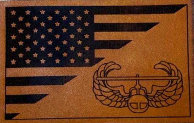 Engraved leather patch showing a flag and insignia
